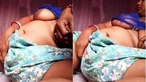 Busty Desi Budi Squeezes and Shakes Her Assets in Seductive Video