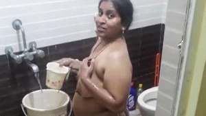 Watch Aunt Dishania's big boobs in a hot bathroom video