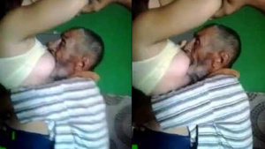 Chubby Arab woman gives breast milk to old man
